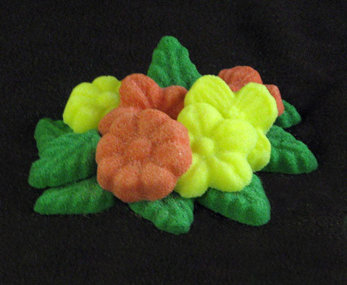 Tea sugars shaped like coral and yellow flowers and green leaves