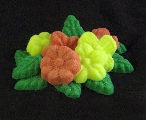 Tea sugars shaped like coral and yellow flowers and green leaves