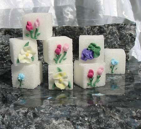 Decorated sugar cubes with yellow, blue, and pink flowers