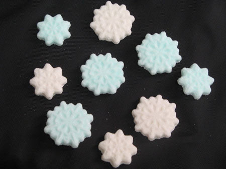 Tea sugars shaped like blue and white snowflakes in two sizes