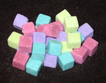Mini-sized sugar cubes in fuchsia, lime, purple, and turquoise